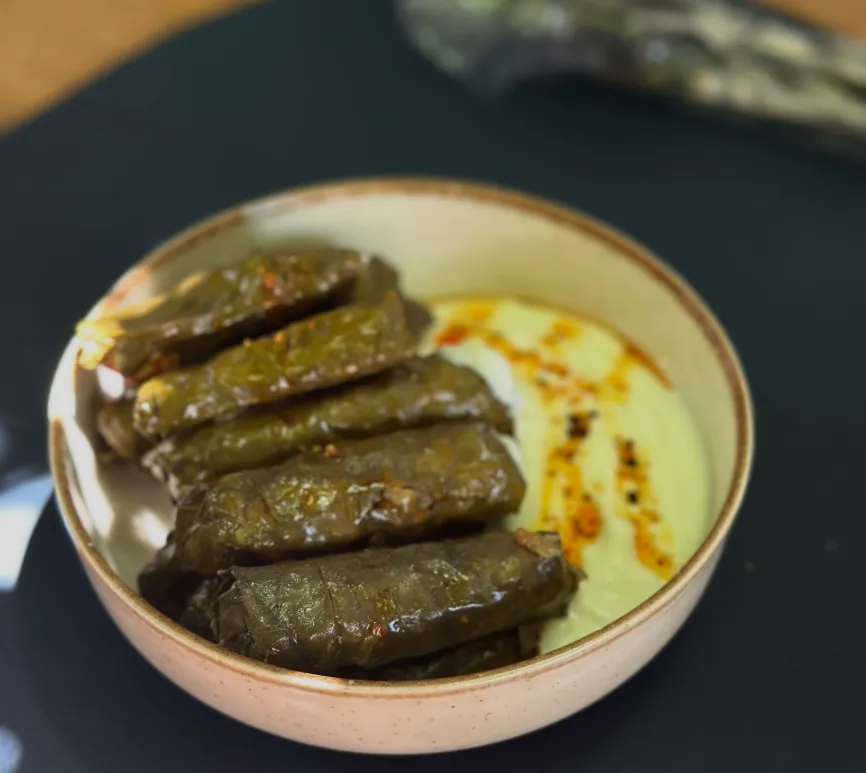 Stuffed vine leaves served with yoghurt at Dolma